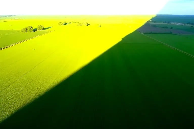 Landscape with dramatic ring shadow band across fields