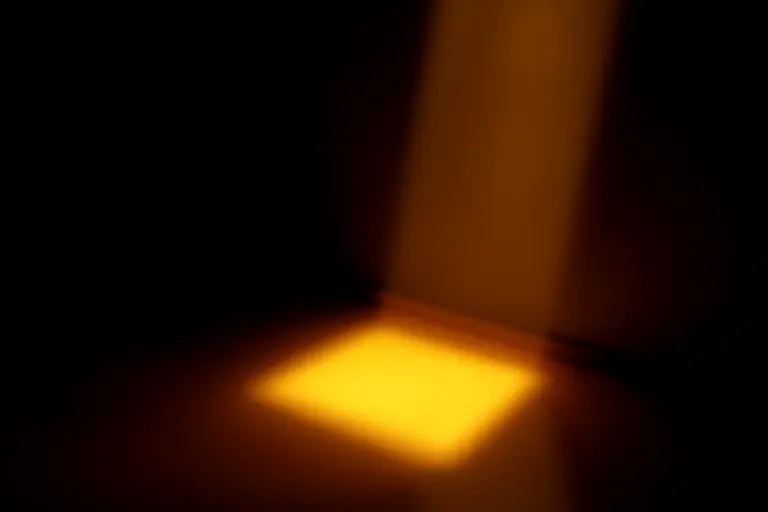 Light slowly creeping across a dark bedroom floor