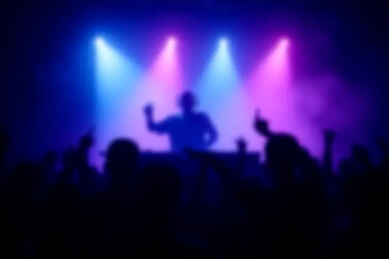 DJ performing to a crowd in a dark club