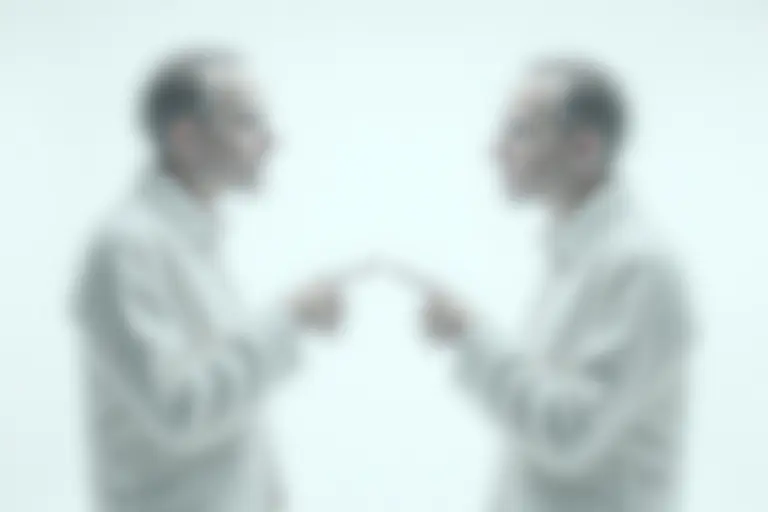 Two identical people facing each other in confusion